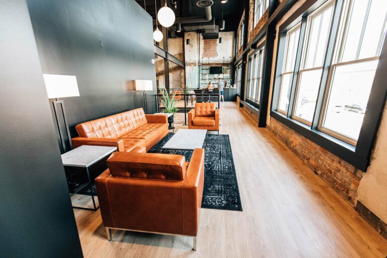 Open loft space with large windows and chairs.