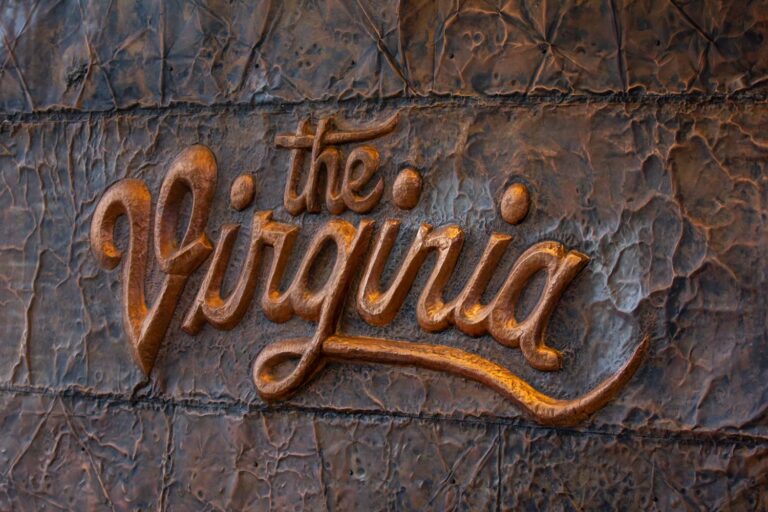 Copper letters on a wall with "The Virginia" script.