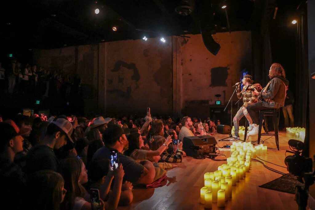 Musicians performing on stage with audience