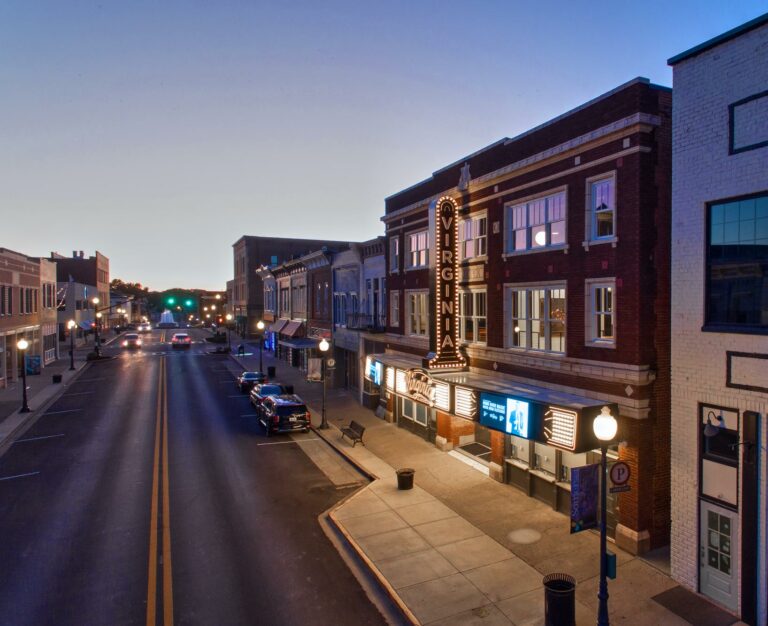 Exterior street view of The Virginia with lighted marquee and twilight skyline.